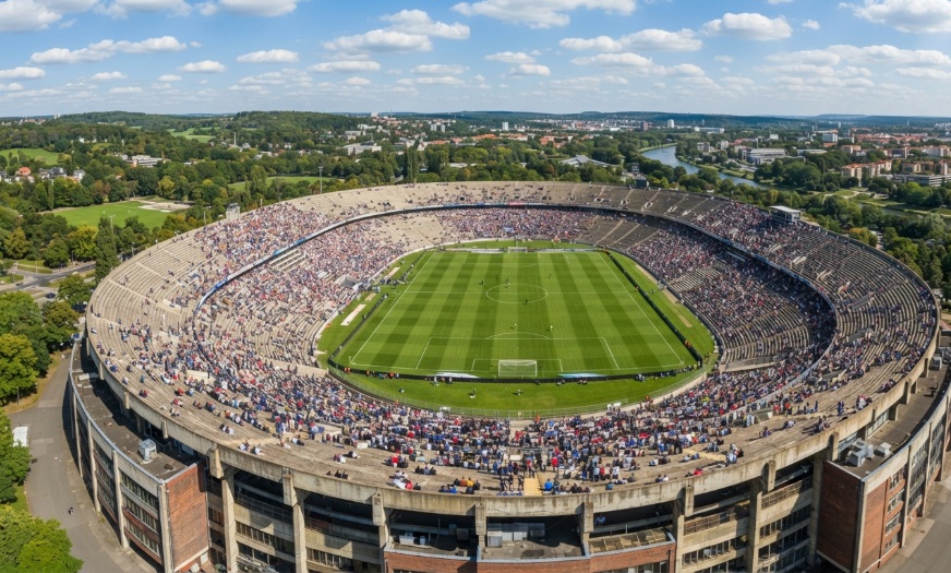 Aerial view of a football stadium showing open airspace above the seating bowl with no roof coverage, highlighting the need for drone detection for stadiums.